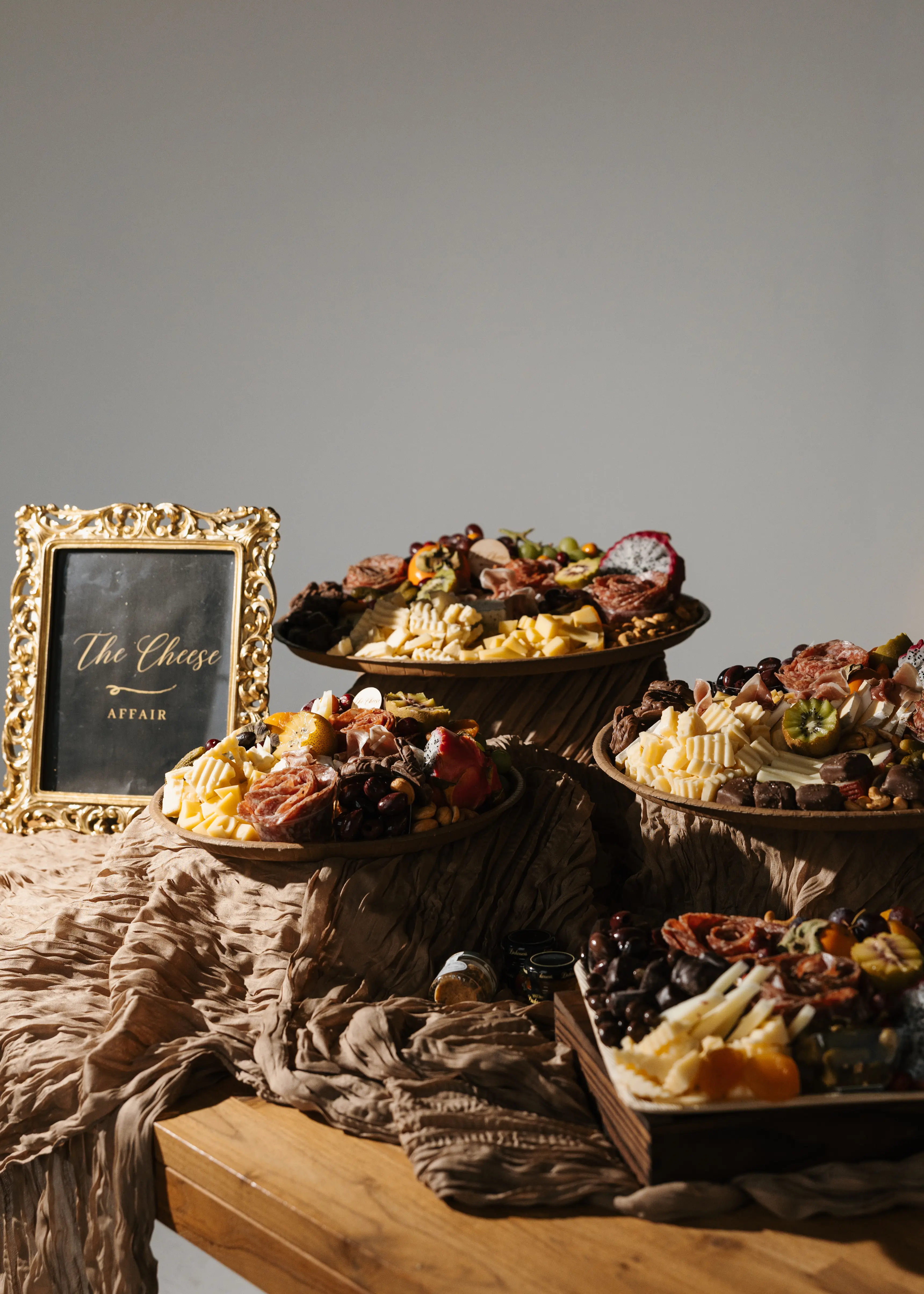 A luxury charcuterie board styled with cheeses, fruit, and elevated details